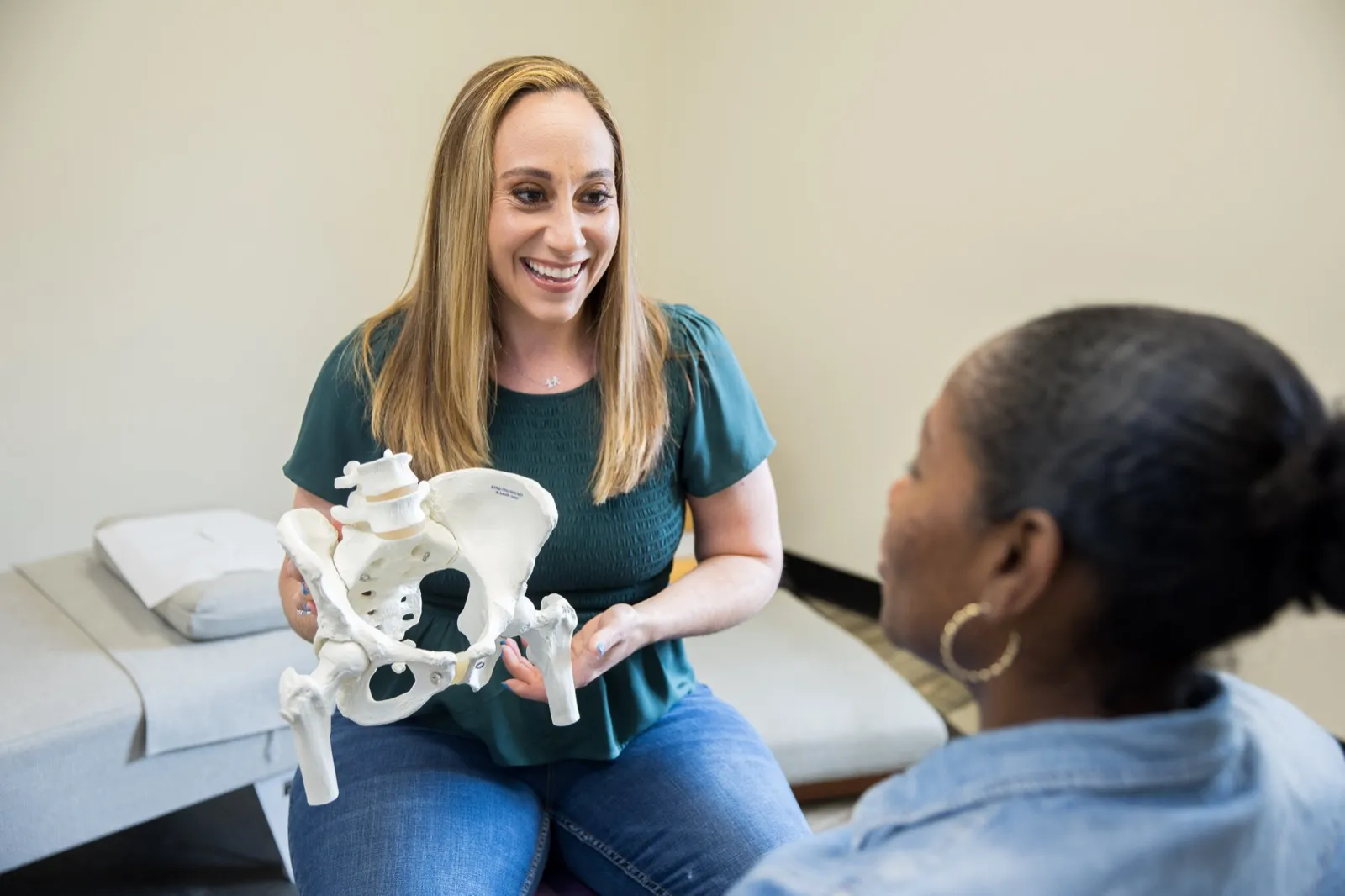 A Flourishing Family doctor talking through pelvic care with a patient in natural light